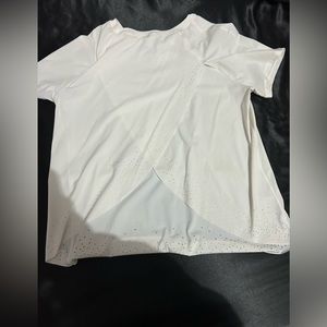 White Lululemon tshirt, size 4, good condition, cut outs along the bottom